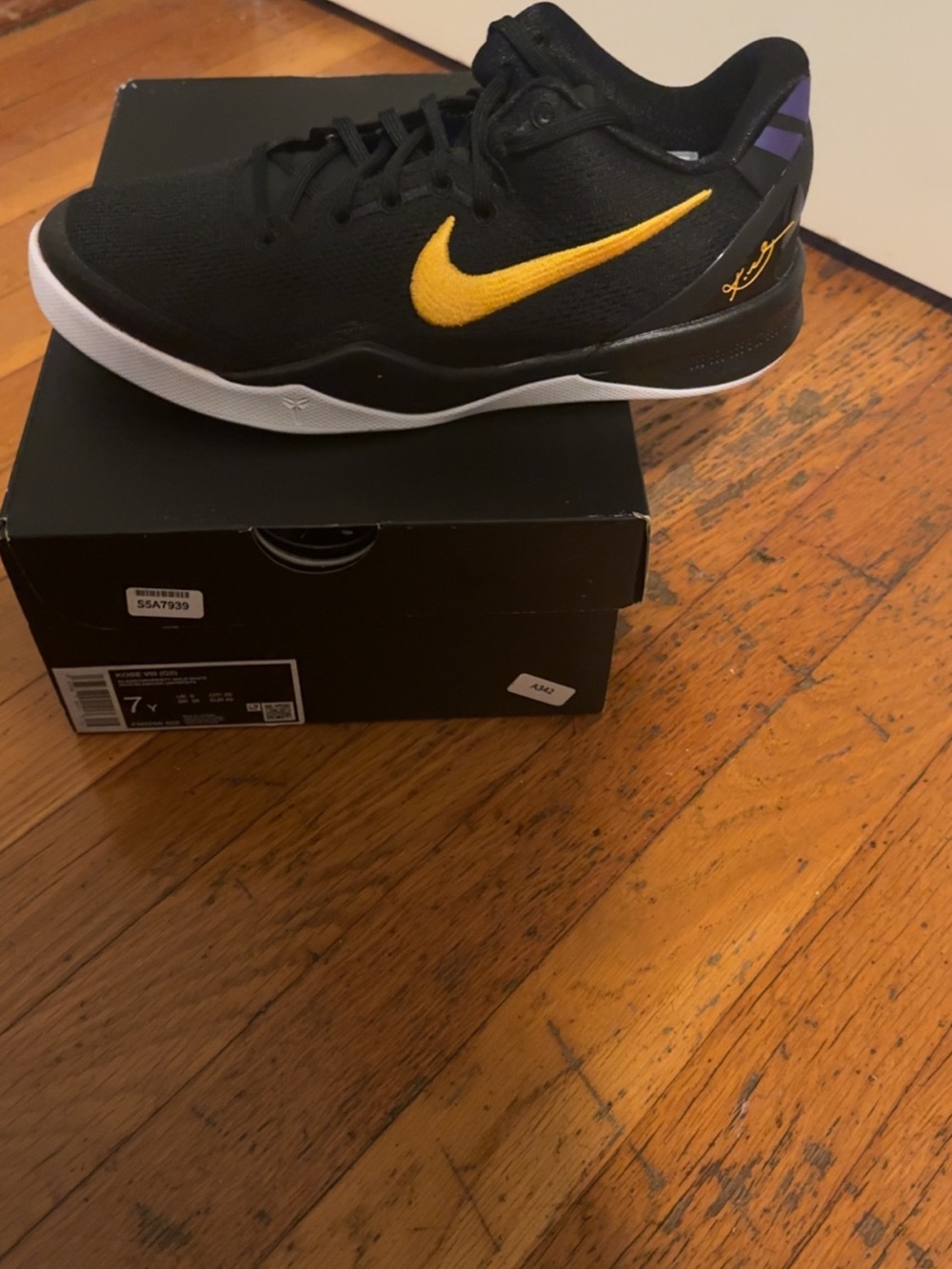 KOBE VIII Nike Kids Black and Gold Low-Top Sneaker with Purple Heel Accent